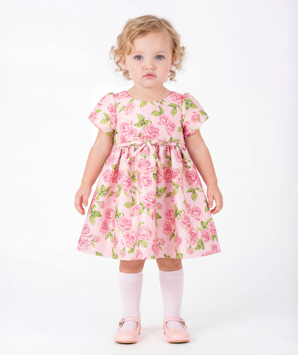 Front view of Rose Bloom Baby Dress in blush pink satin for babies 12 to 36 months, showing overall silhouette and styling
