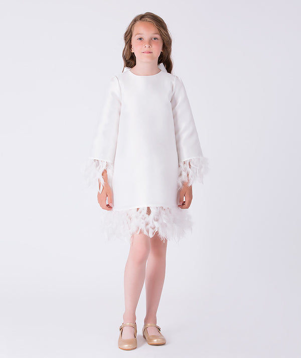 Front view of ivory girls dress with feather trim hem and cuffs, long sleeves and elegant A-line silhouette.