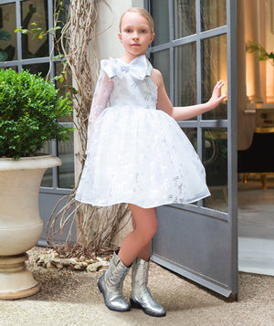 Model wearing Shimmering Kids Cowboy Boots in silver, from Mama Luma’s premium children’s occasionwear