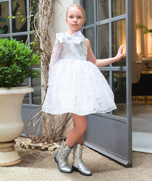 Model wearing Shimmering Kids Cowboy Boots in silver, from Mama Luma’s premium children’s occasionwear