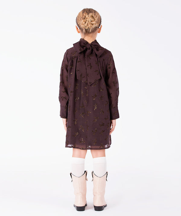 Back view of Shimmering Mocha Girls Dress featuring an oversized neck bow and shimmering details for girls ages 3 to 12 by Mama Luma.