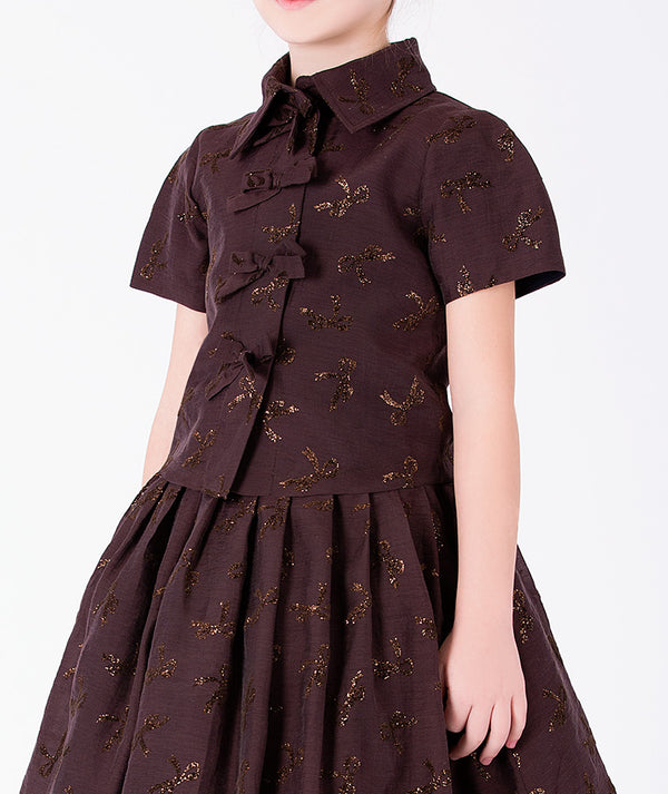 Detail view of Shimmering Mocha Girls Outfit with metallic bow motifs and decorative bow closures for girls ages 3 to 12 by Mama Luma.