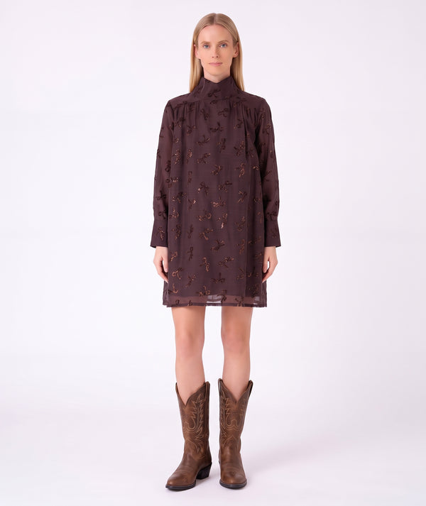 Front view of Shimmering Mocha Women's Dress featuring metallic bow motifs and long sleeves by Mama Luma.