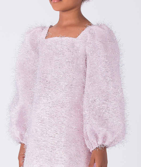Close-up of the shimmering fabric and puff sleeve detail on a girls party dress, highlighting texture and refined design.