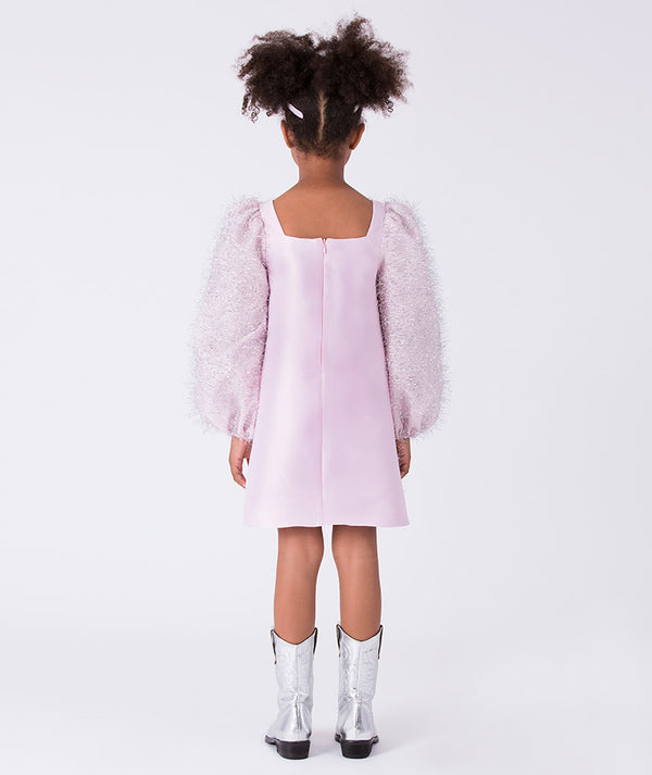 Back view of a girls party dress with puff sleeves and clean silhouette, finished with a concealed zipper closure.