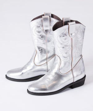 Silver metallic cowboy boots for girls featuring detailed stitching and a mid-calf design — perfect for parties, fashion photoshoots, and festive occasions.