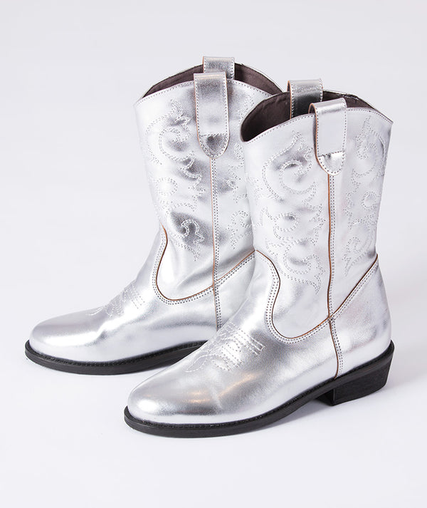 Silver metallic cowboy boots for girls featuring detailed stitching and a mid-calf design — perfect for parties, fashion photoshoots, and festive occasions.