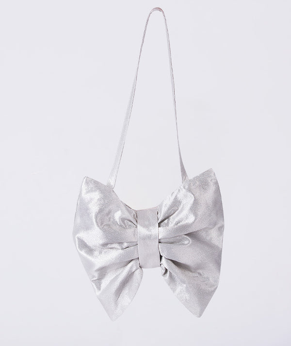 Silver bow-shaped handbag on a light gray background