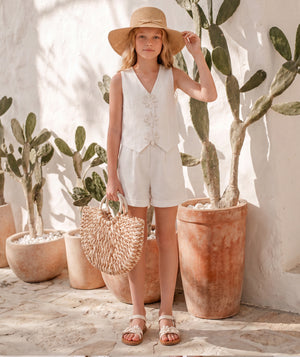 Editorial view of Sun Appliqués Girls Linen Outfit | 2 Pieces for girls ages 3 to 12, featuring fabric texture and color