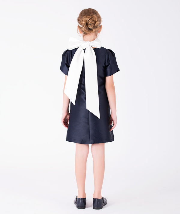 Back view of Suva Maia Flower Girls Dress in ivory satin for girls ages 3 to 12, showing the silhouette and refined construction