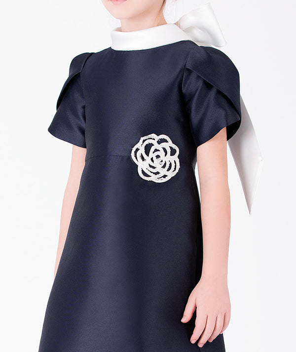 Editorial view of Suva Maia Flower Girls Dress in ivory satin for girls ages 3 to 12, styled for weddings, birthdays and special occasions