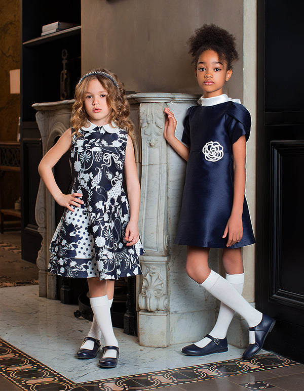 Lifestyle view of Suva Maia Flower Girls Dress in ivory satin for girls ages 3 to 12, a premium children’s design by Mama Luma