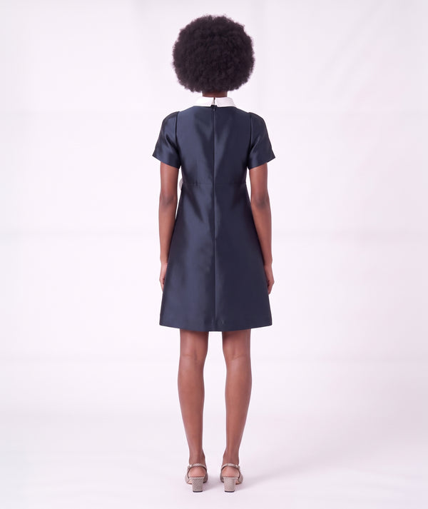 Back view of the Suva Maia Flower Women’s Dress in navy with an ivory high collar and tailored A-line silhouette by Mama Luma.