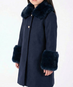 Close-up of the navy Mama Luma girls coat showing its soft faux-fur collar and cuff details from the Suva Maia Collection.