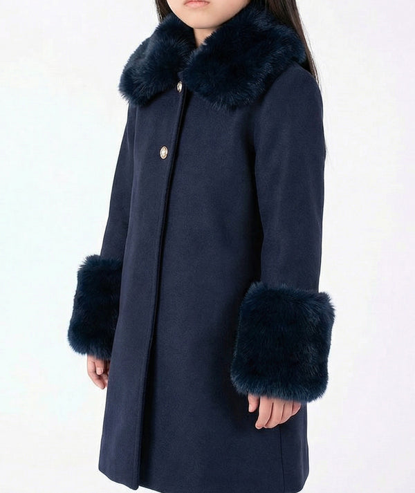 Close-up of the navy Mama Luma girls coat showing its soft faux-fur collar and cuff details from the Suva Maia Collection.
