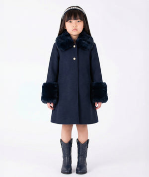 Front view of Mama Luma Suva Maia navy girls coat with plush faux-fur collar, oversized cuffs and flared silhouette for fall and winter occasions.