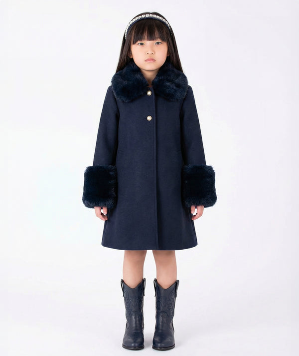 Front view of Mama Luma Suva Maia navy girls coat with plush faux-fur collar, oversized cuffs and flared silhouette for fall and winter occasions.