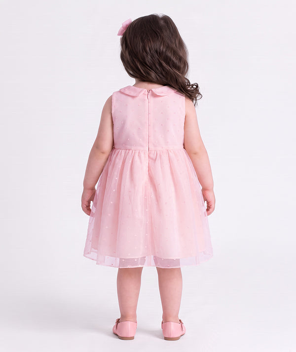 Back view of the Swiss Dot Pink Baby Girl Dress by Mama Luma, an elegant pink baby dress for birthdays and special occasions.
