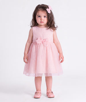 Front view of the Swiss Dot Pink Baby Girl Dress by Mama Luma, featuring a soft pink special occasion silhouette for baby girls.