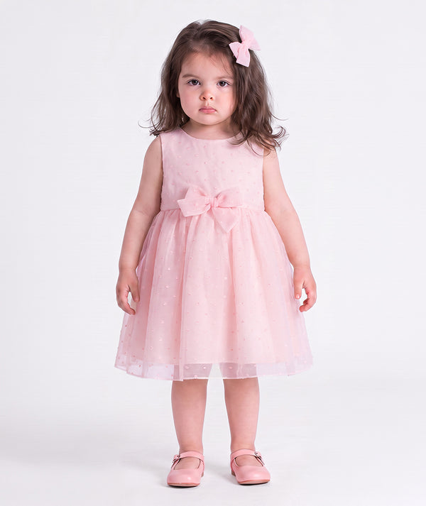 Front view of the Swiss Dot Pink Baby Girl Dress by Mama Luma, featuring a soft pink special occasion silhouette for baby girls.