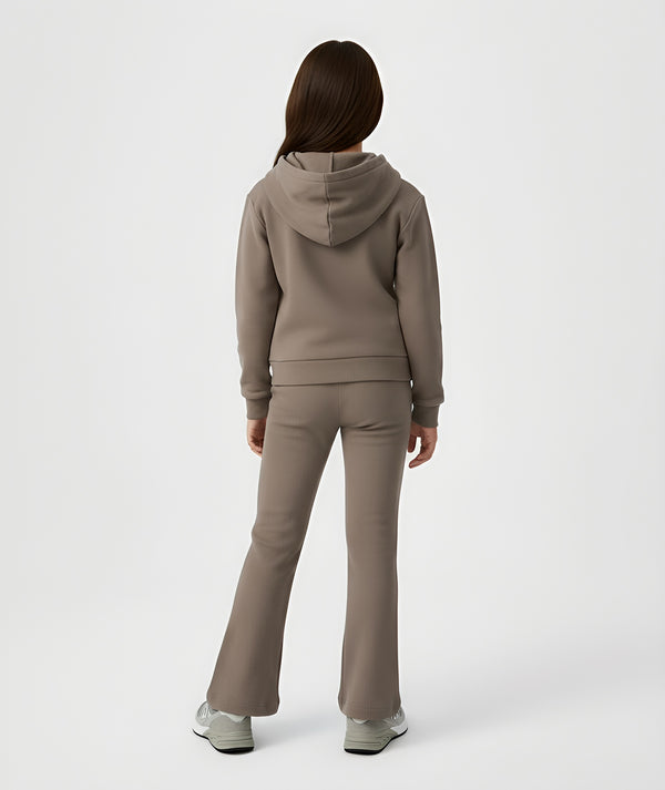 Girls coordinated taupe athleisure set featuring a short sleeve t-shirt and ribbed pants, worn from the back for casual outings and everyday comfort, available in sizes 3–14