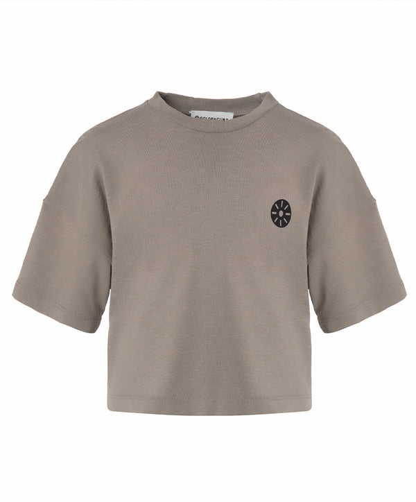Alternate front view of a taupe short sleeve girls t-shirt with a relaxed cropped silhouette and minimalist black chest emblem, designed for everyday wear, school outfits, and casual looks, available in sizes 3–14