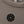 Carica l'immagine nel visualizzatore Galleria, Close-up detail of a taupe girls sleeveless tank top highlighting the ribbed neckline, soft knit texture, and minimalist chest emblem, designed for everyday wear, school outfits, and casual looks, available in sizes 3–14
