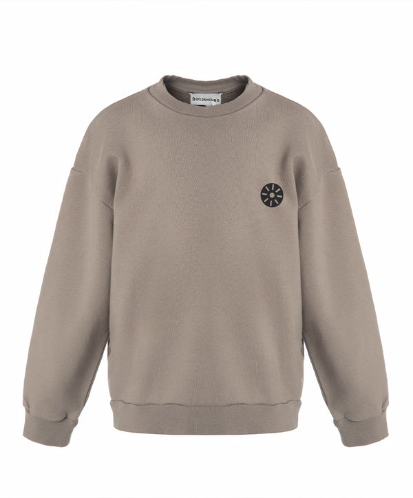Front view of a taupe girls sweatshirt with a relaxed fit and minimalist chest emblem, designed for everyday wear, school outfits, and casual layering, available in sizes 3–14