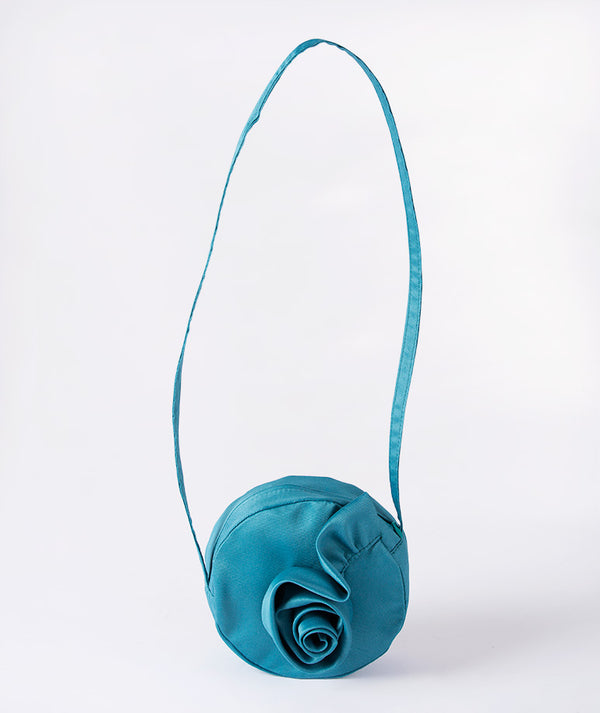 Teal blue girls’ round handbag with a signature rose detail — an elegant accessory for weddings, birthdays, and festive occasions. Perfectly pairs with Mama Luma’s teal collection
