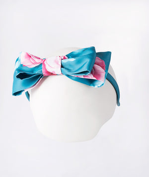 Teal floral bow headband for girls featuring pink rose prints on satin fabric — a charming accessory for weddings, parties, and festive occasions