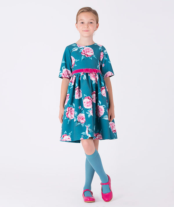 Teal floral dress for girls with pink roses and velvet bow belt, combining charm and elegance — ideal for birthdays, weddings, and garden parties. Available in sizes 3–12Y