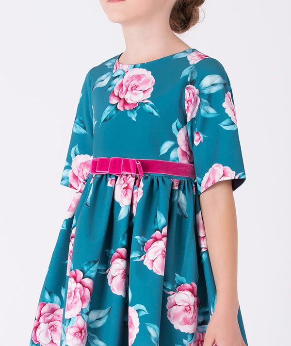 Close-up of teal floral dress for girls with a pink velvet bow belt, showcasing elegant rose prints — perfect for weddings, tea parties, and family celebrations. Available in sizes 3–12Y