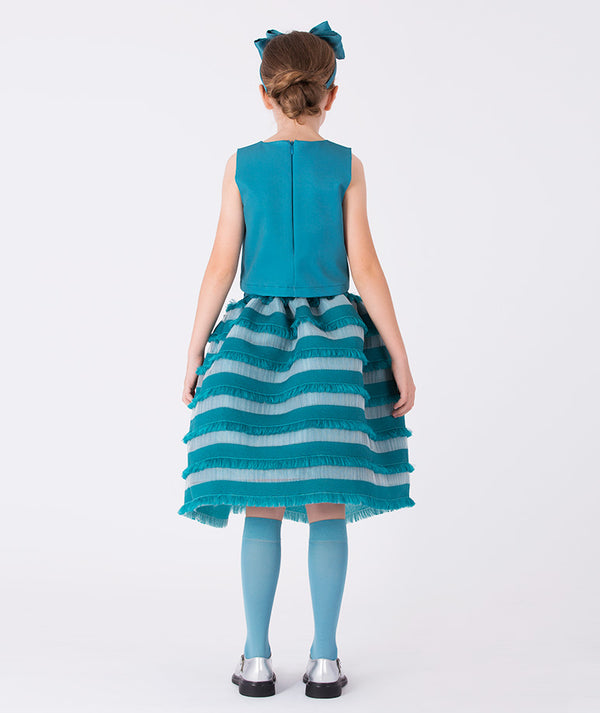 Back view of teal striped girls’ dress (3–12Y) with a sleeveless bodice and layered ruffle skirt, styled with matching bow and socks — perfect for parties, weddings, and special events