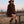 Carica l'immagine nel visualizzatore Galleria, Textured Faux Fur Women's Coat in mocha styled in a ranch setting, featuring plush long-pile texture and a self-tie belt by Mama Luma.

