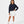 Carica l'immagine nel visualizzatore Galleria, Front-facing lifestyle image of a girl wearing a navy long sleeve sweatshirt with white shorts, styled for transitional weather outfits, casual school days, and relaxed movement, available in sizes 3–14
