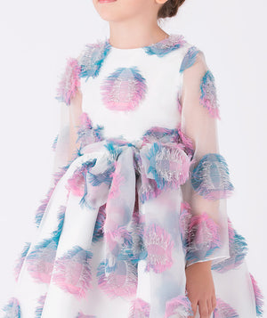 Close-up of a white organza girls’ dress (3–12Y) with 3D pastel feather appliqués in pink and blue, featuring a statement bow — perfect for weddings, birthdays, and festive occasions
