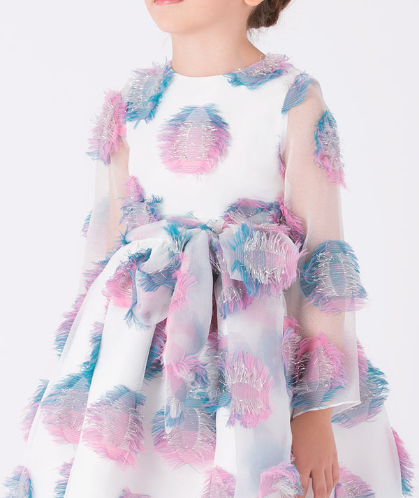 Close-up of a white organza girls’ dress (3–12Y) with 3D pastel feather appliqués in pink and blue, featuring a statement bow — perfect for weddings, birthdays, and festive occasions