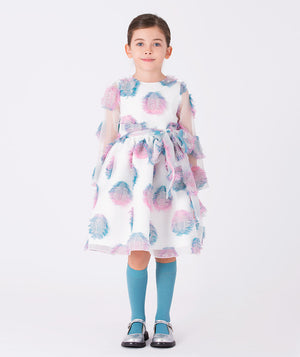 Girl wearing a white organza dress (3–12Y) adorned with pink and blue 3D feather appliqués and a statement bow, perfect for weddings, birthdays, and special celebrations