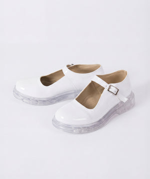 White shoes with clear soles on a light gray background