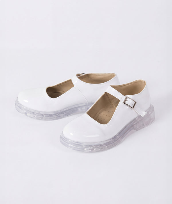 White shoes with clear soles on a light gray background