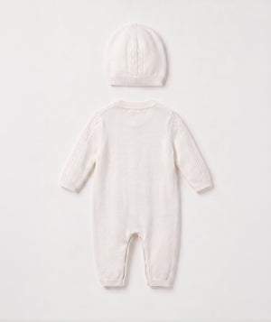 Ivory cable knit baby romper with matching beanie luxury newborn knit outfit perfect for special occasions