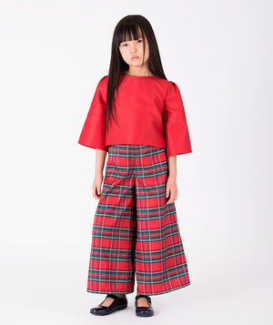 Front view of Mama Luma Ball Sleeve Girls Outfit featuring a scarlet-red bell-sleeve top and wide-leg tartan trousers from the Zermatt Collection.