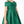 Load image into Gallery viewer, Close-up of Mama Luma Enchanting Bow Girls Holiday Dress featuring an oversized emerald-green shoulder bow and structured pleated skirt.
