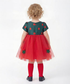 Back view of Mama Luma Zermatt baby girl Christmas dress featuring short puff sleeves, a concealed zipper, and scarlet tulle with festive tree appliqués.