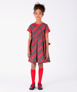 Front view of Mama Luma Tartan Bow Girls Dress featuring red, green, and navy tartan checks, short sleeves, and a pleated skirt for girls ages 3 to 12.